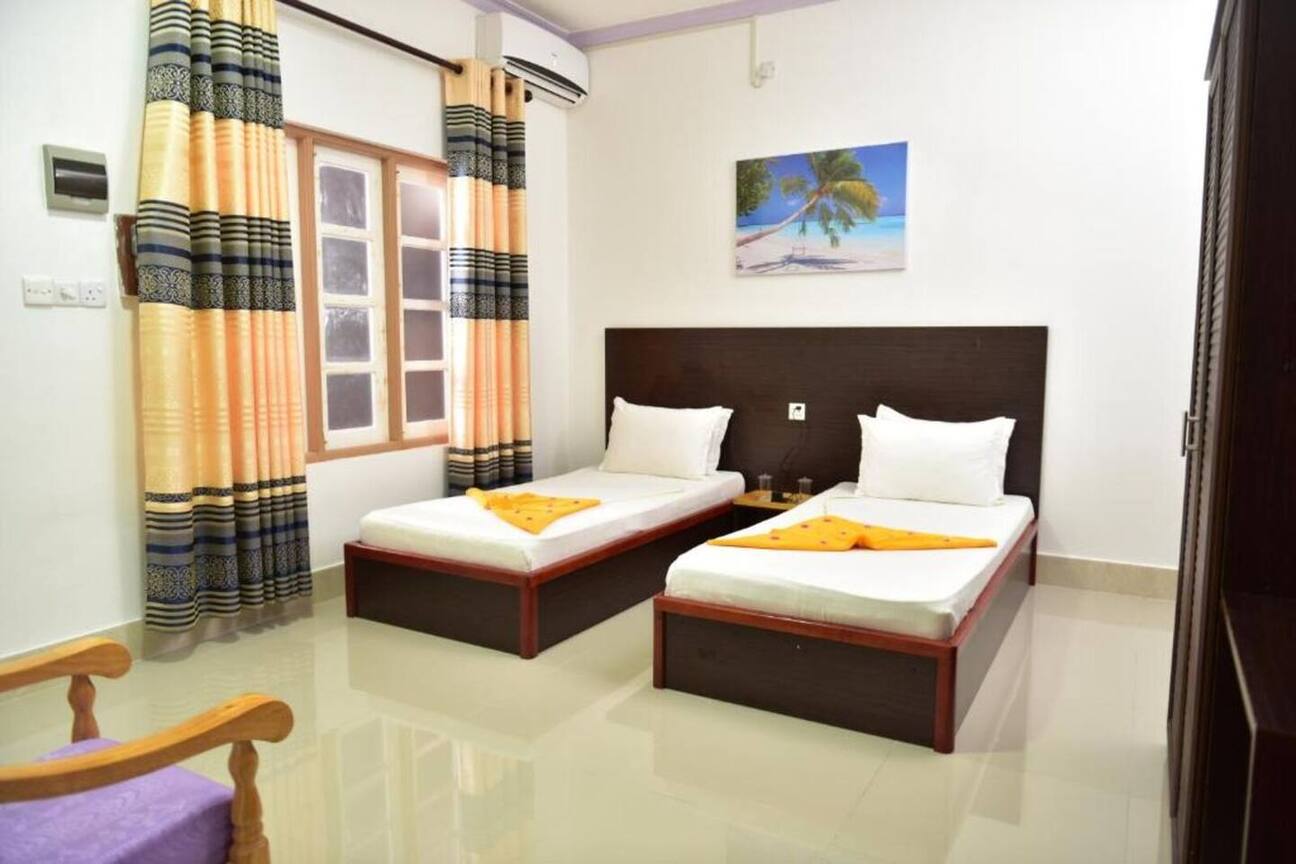 Deluxe twin room with two single beds at Moodhumaa Inn